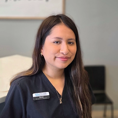 Chiropractic Assistant Monse Smiling In Office